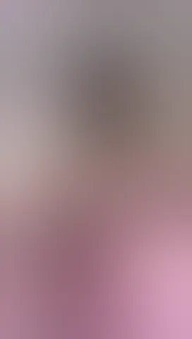 She adjusts her glasses slowly, teasing the camera.