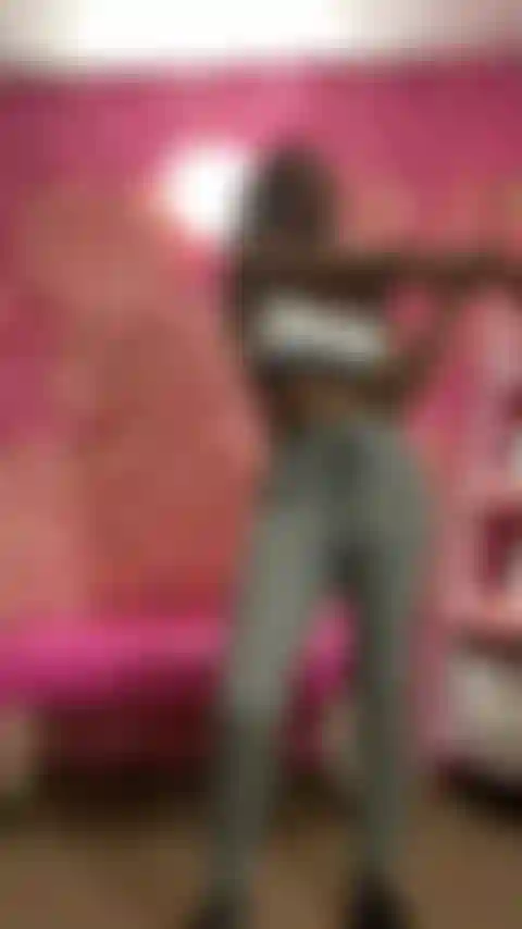 Stretching In Grey Sweats And Sports Bra