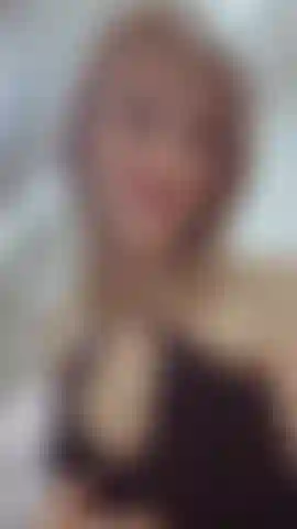 The thin fabric falls softly over the body, outlining the silhouette. There is a challenge in her eyes, and the grace of a predator in her movements.