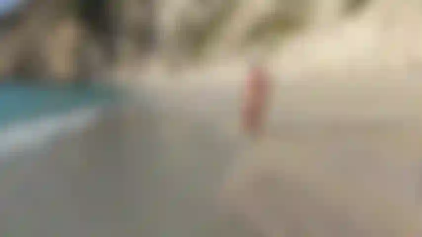 Teasing, stretching and posing in doggy style at a nude