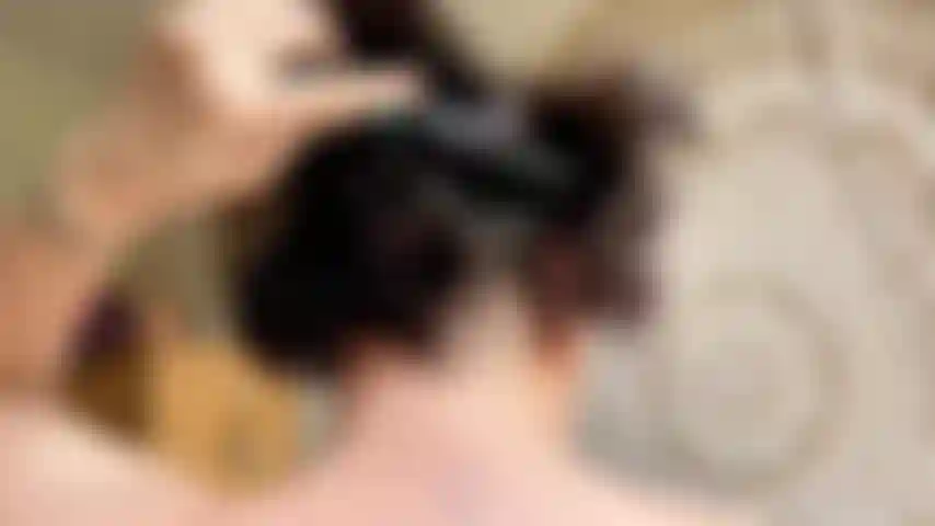 brushing hair comb head close up earrings