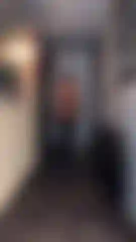 Latex chaps slow mo walk from front & behind.