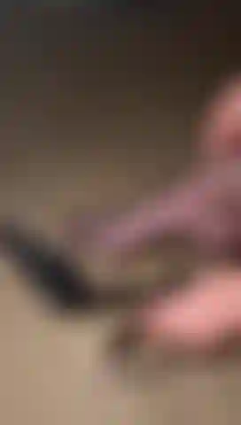 Foot in nylons, putting on my heels.