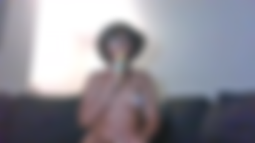 Topless ebony with lollipop.