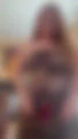 Stripping completely out of a sexy outfit in a naughty seductive way.