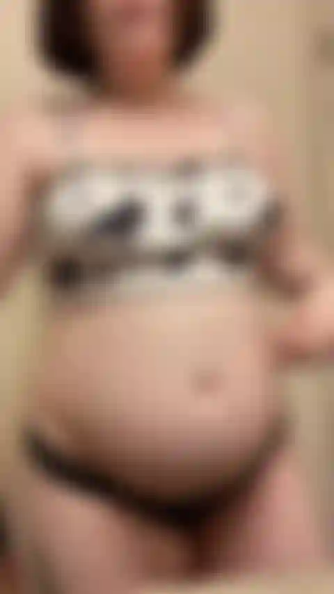 26 weeks pregnant belly and breast oiled close up