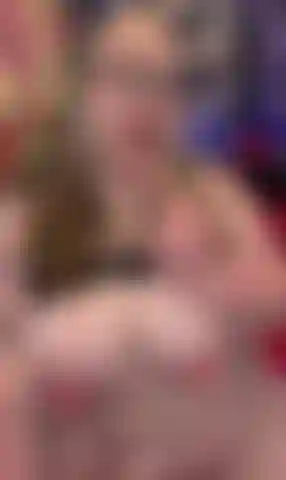 Sucking on dildo with tits out.