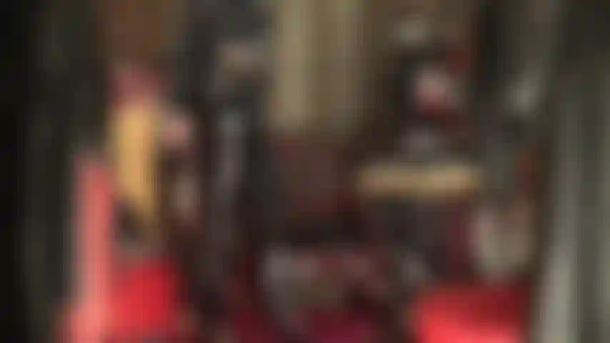 Pvc fetish - fully dressed in shiny black vinyl, mistress teases the pvc fetishist with shiny jeans, heels, and long coat.