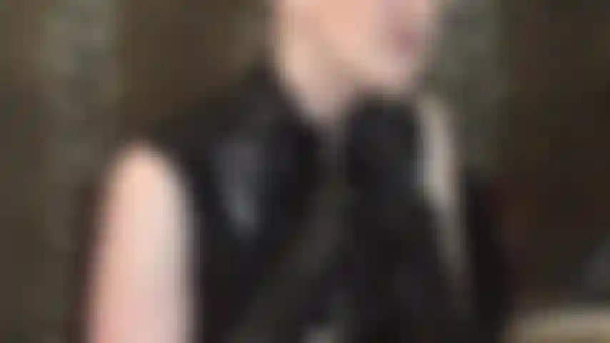Seductive cleavage tease in pvc zip dress.