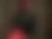 Latex layers - mistress adds a black blouse to her rubber outfit.