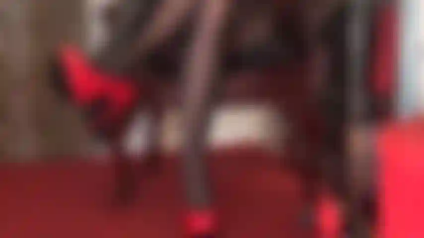 Shiny red stilettos, black leather gloves and black pantyhose legs are pure seduction.