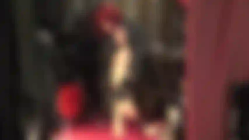 Goddess in leather teases you with her hot legs in glossy tan pantyhose and red ankle strap sandals.