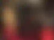 Blonde mistress in tight shiny pvc catsuit.