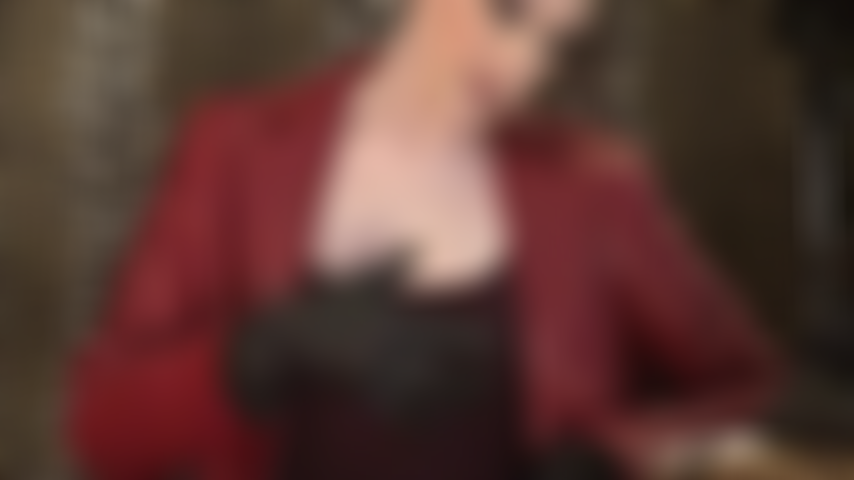 Mistress teases with her wonderful cleavage in a sexy burgundy tank dress.