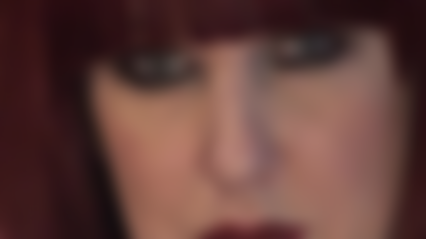 Mistress' hypnotic face - luscious red lips and piercing blue eyes that look straight into your soul.