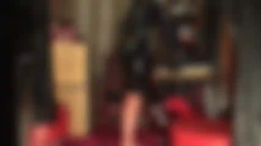 Shiny rubber outfit, stockings and mask - goddess shows of her curves in tight latex, transparent seamed stockings and black pencil skirt with gloves. The outfit is completed with a latex mask.