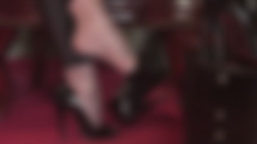 Closeup of Mistress' feet dangling shiny patent open toe pumps in super glossy gray pantyhose.