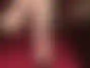 Bare foot dangling black leather mules.