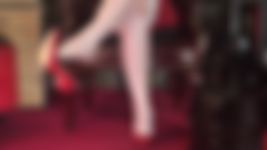 Mistress unlayers her glossy layers of pantyhose and stockings down to the last pair of extra shiny tan hose showing off her sexy feet.