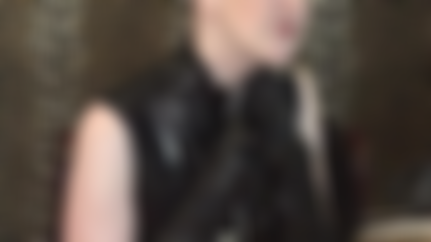 Seductive cleavage tease in pvc zip dress.