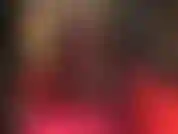 Sensual leg tease in sexy red dress and black pantyhose and metal stiletto peeptoes. Crossed legs, extended leg fetish, high heels.