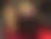 Shiny gold satin shorts, glossy pantyhose and tall boots.