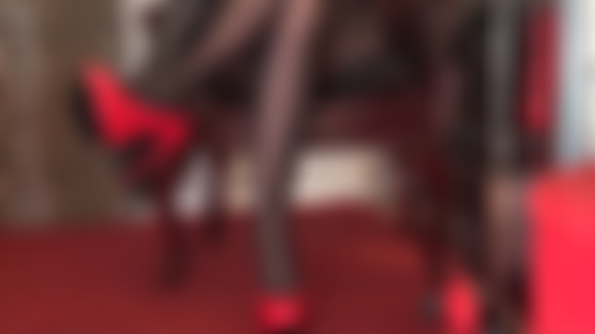 Shiny red stilettos, black leather gloves and black pantyhose legs are pure seduction.