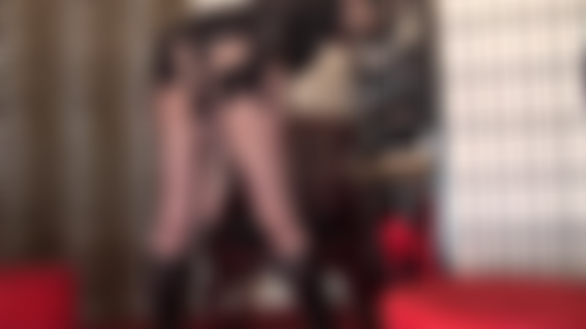 A view from behind as Mistress strokes and thrusts a big white strap-on.
