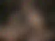 Leather goddess wearing sexy glasses, strokes her huge white strapon.