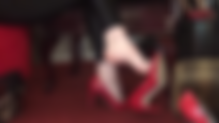 Barefoot tease - bare feet in red leather pumps, toes, dangling.