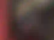 Mistress dressed in shiny black vinyl catsuit, straps on one of her huge cocks, a white thick strapon, thrusting and spanking.