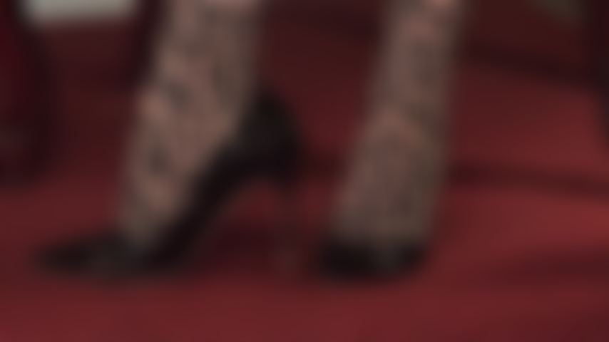 Shiny high heel perfection - Wearing a pair of leopard print pantyhose, Mistress models her shiny black patent pumps.