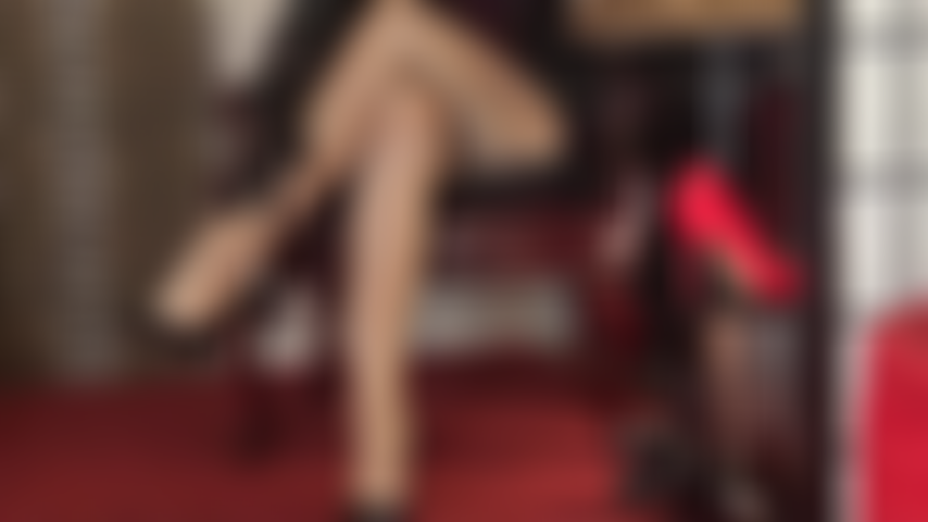 Sexy crossed legs in glossy tan pantyhose are teasing the leg lover. Mistress adds an additional shiny pair of nylons for an irresistible shine.