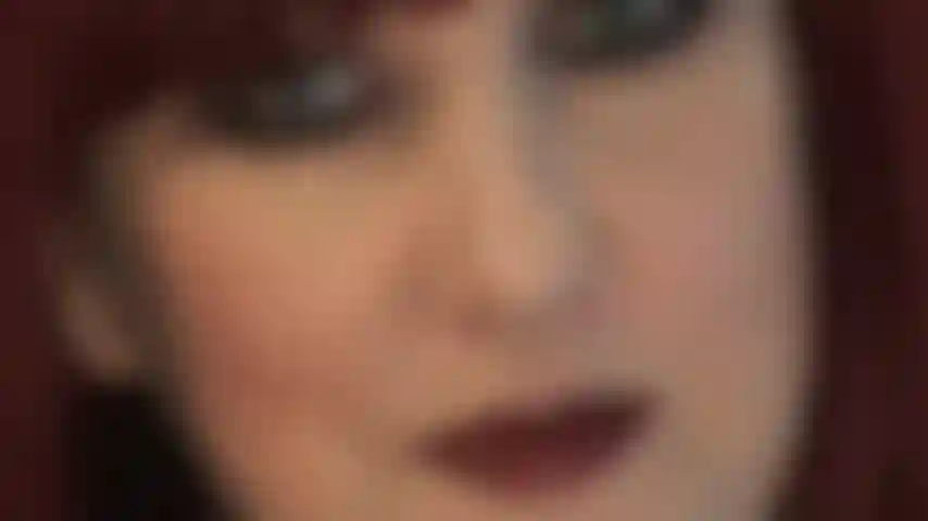 Extra glossy dark lips and seductive eyes.