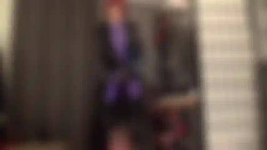 Shiny heavy pvc coat over purple leohex suit with stryker strapon and boots.