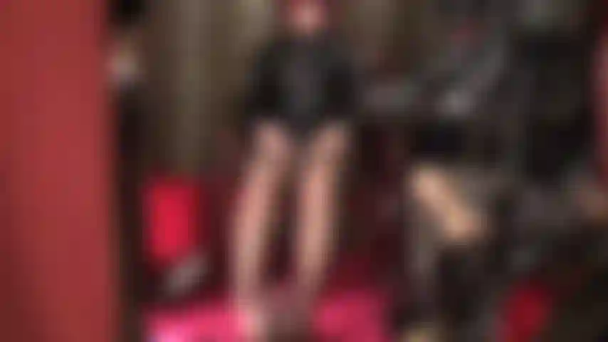 Mistress strokes two cocks - dressed in shiny pvc and brown pantyhose, her feet are wrapped around black cock while mistress strokes her white strap-on with bare hands.