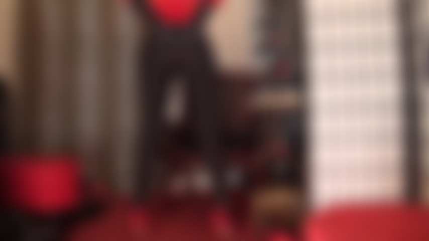 Ass worship in red and black - Shiny black lycra leggings accentuate Mistress' round butt.