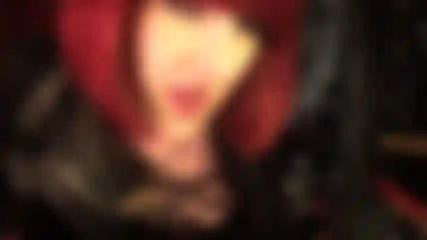 Spit is dripping from mistress' hot red lips and wet tongue.