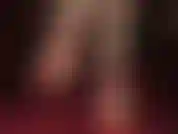 Bare foot fetish in red ankle strap stiletto heels, dangling.