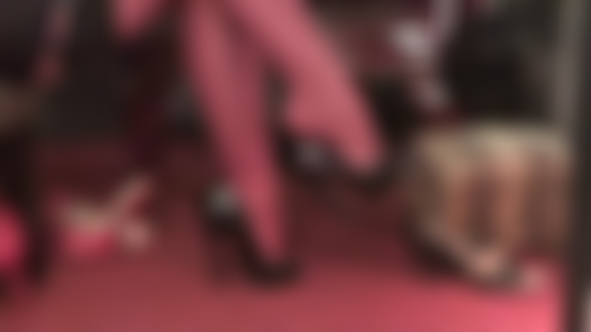 Watch the dangling queen in red garter stockings and black patent peeptoes.