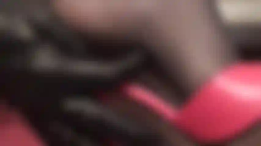 Upclose and personal with mistress' heels and feet in black nylons and red mules.