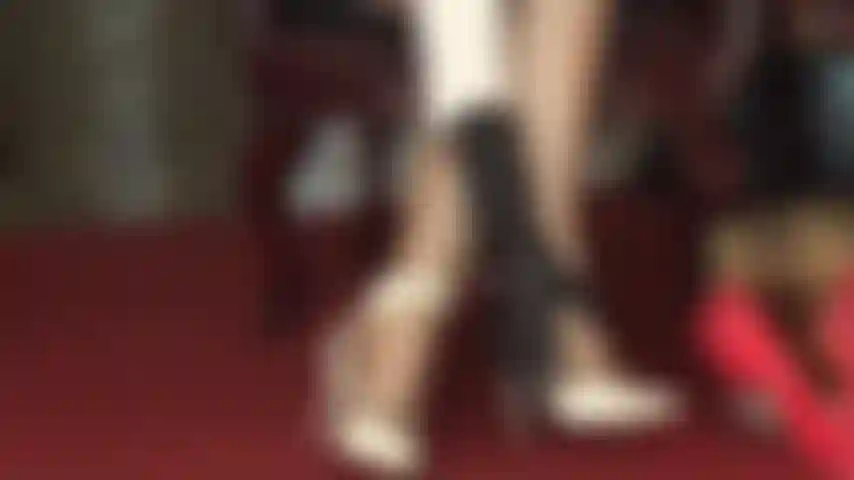 Strappy white sandals and glossy pantyhose foot tease.