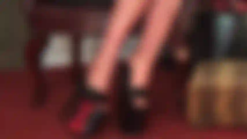 Feet in latex stockings and platform heels.