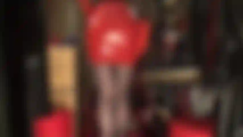 Sexy red latex skirt, rubber gloves, black pantyhose and red heels.