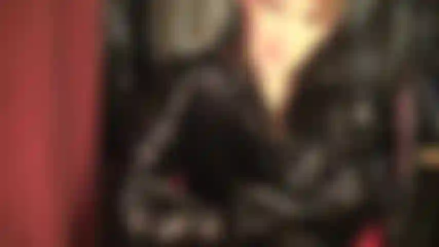 A shiny pvc fetish dream comes true - admire mistress vivian in a wonderful glossy black vinyl outfit with tall overknees boots and long coat.