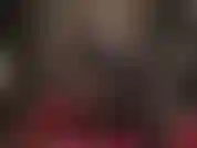 Slipping on black and red latex stockings and shoulder length gloves as well as shiny peeptoe pumps.