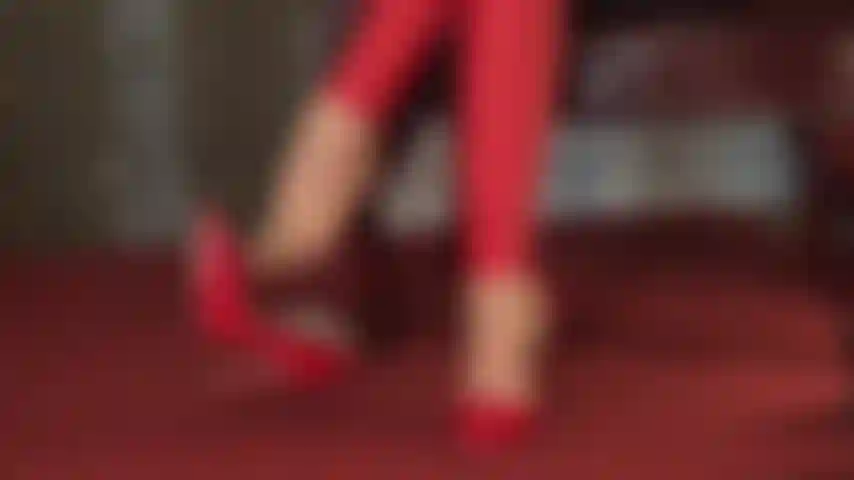 Red heels, dangling in tights and leggings.