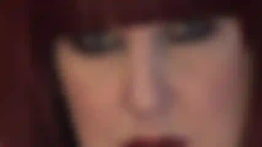 Mistress' hypnotic face - luscious red lips and piercing blue eyes that look straight into your soul.