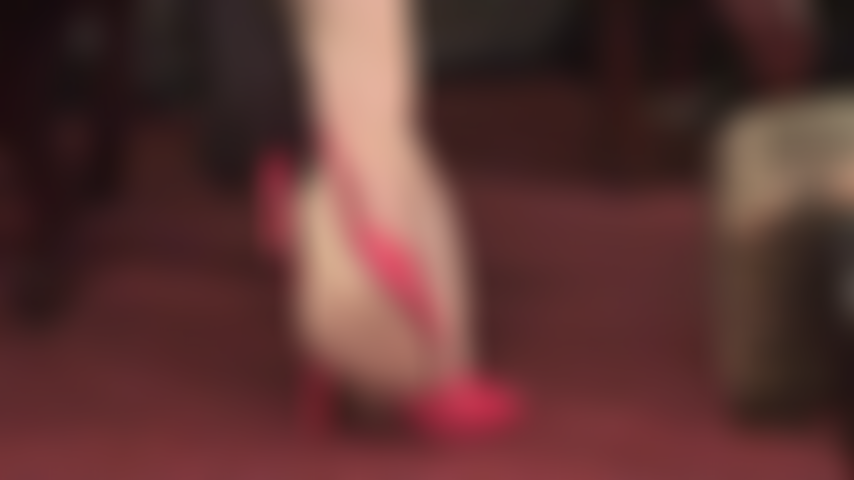 Red stiletto mules and sheer nude reinforced pantyhose toes entice the foot lover.