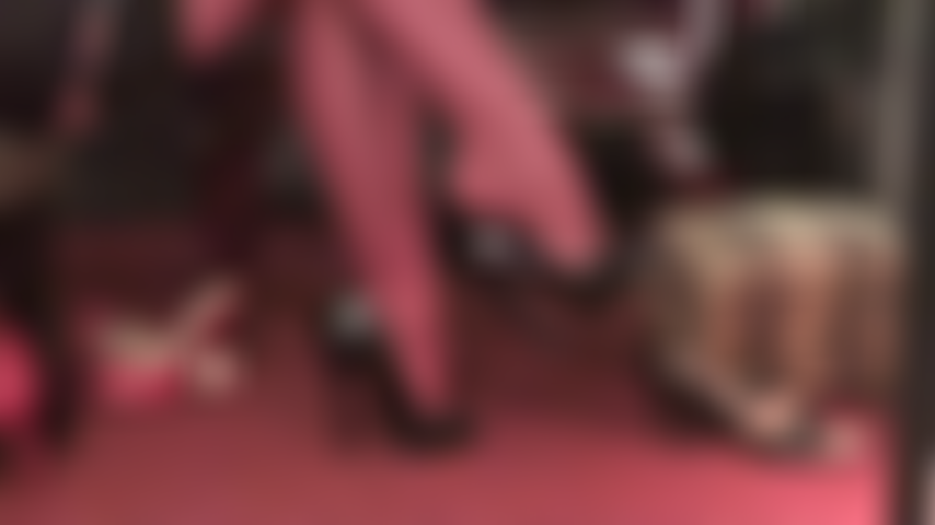 Watch the dangling queen in red garter stockings and black patent peeptoes.